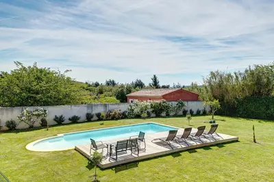 a yard with a swimming pool with chairs and a fence at Les Hauts de Provence - Maison avec piscine in Aix-en-Provence