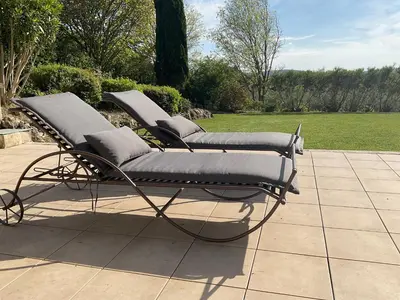 a pair of reclining chairs on a patio at Mas la Floreline in Cheval-Blanc