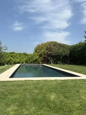 a swimming pool in the middle of a grass field at Maison familiale avec piscine in Aix-en-Provence