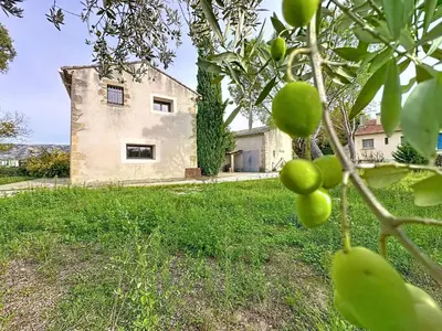 a kitchen with a wooden cabinet and a stove at les gites de la Fée in Cavaillon