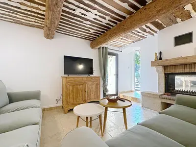 a bathroom with a toilet and a tv on a wall at les gites de la Fée in Cavaillon