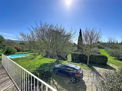 a kitchen and dining room with a large island with stools at les gites de la Fée in Cavaillon