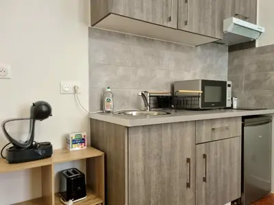 a kitchen with a sink and a microwave at Studio centre historique 2 in Aix-en-Provence