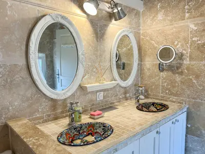 a bathroom with two sinks and two mirrors at Mazet des Balestiés cœur Luberon 120 m2 6 pers avec piscine in Gargas