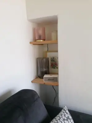 a room with a couch and a shelf with a radio at Le Mazet d'Alexis in Maubec