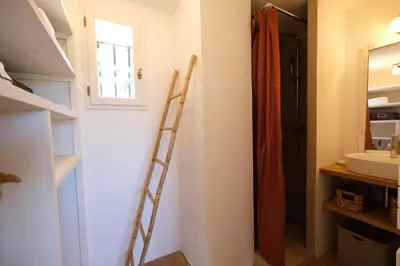a ladder in a bathroom with a sink and a mirror at Air-conditioned villa with private pool overlooking Roussillon - Luberon - 8 people. in Roussillon