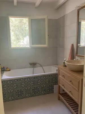 a bathroom with a bath tub and a sink at Villa Paradis des Oréades in Lauris