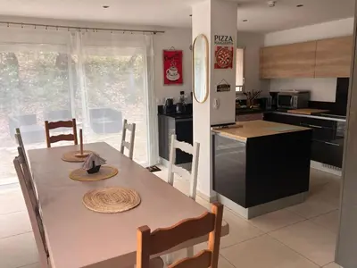 a kitchen with a table with two hats on it at Villa Paradis des Oréades in Lauris