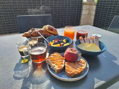 a table with a tray of breakfast foods and drinks at Domaine de la Mautanne in Sainte-Tulle