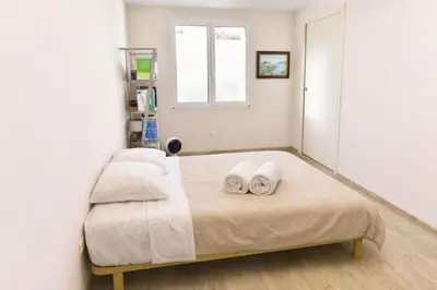 a bedroom with a bed with two towels on it at La Maison Bleue in LʼIsle-sur-la-Sorgue