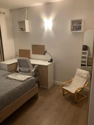 a room with a bed and a desk and a chair at appartement T3 golf in Mallemort