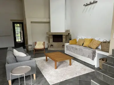 a living room with a couch and a table at Bergerie de charme proche Aix en Provence et Lubéron in Rognes