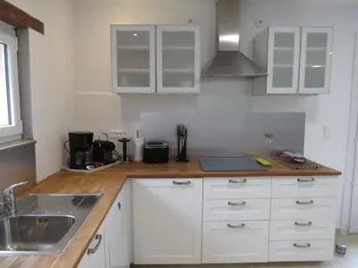 a kitchen with white cabinets and a sink at Maison face au Luberon avec piscine - 5 Chambres in Cabrières-dʼAvignon