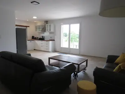 a living room with two couches and a table at Maison face au Luberon avec piscine - 5 Chambres in Cabrières-dʼAvignon