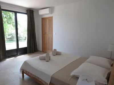 a white bedroom with a large bed and a large window at Maison face au Luberon avec piscine privée - 3 Chambres in Cabrières-dʼAvignon