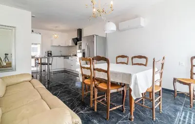a kitchen and dining room with a table and chairs at 2 Bedroom Nice Home In Chateaurenard in Châteaurenard