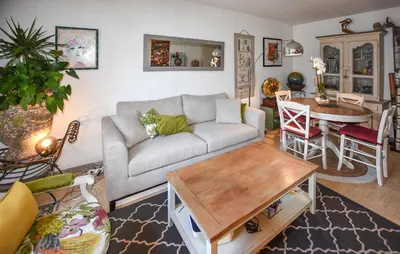 a living room with a couch and a table at Nice Apartment In L'isle-Sur-La-Sorgue in LʼIsle-sur-la-Sorgue