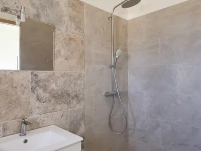 a bathroom with a shower and a sink at Logement au calme à LOURMARIN in Lourmarin