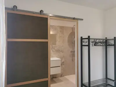 a sliding glass door in a bathroom with a shower at Logement au calme à LOURMARIN in Lourmarin