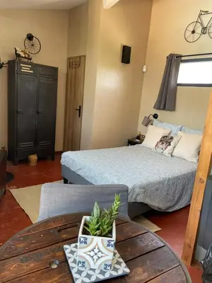 a bedroom with a bed and a table with a coffee table at Studio Le Pitchoun in Pernes-les-Fontaines