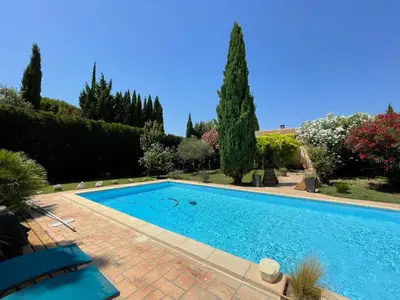 a swimming pool in a yard with trees and bushes at Studio Le Pitchoun in Pernes-les-Fontaines