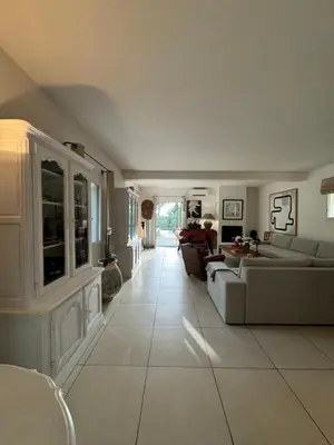 a large living room with couches and a table at Les Feuilleres in LʼIsle-sur-la-Sorgue