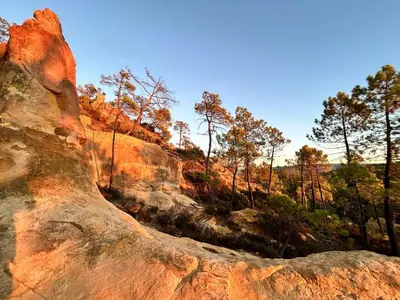 a view of a rock with trees in the background at Les Cachots in Roussillon