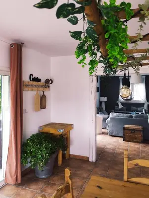 a living room with a table and a couch at Villa face au Mont Ventoux avec bassin in Modène