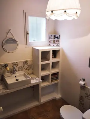a bathroom with a sink and a mirror at Villa face au Mont Ventoux avec bassin in Modène