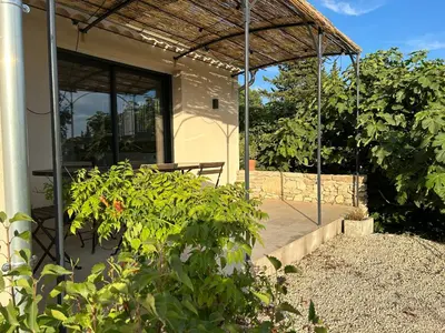 a house with a patio with a roof at Maison avec jardin in Saumane-de-Vaucluse