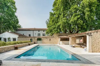 a swimming pool in the backyard of a house at Beautiful Provencal Mas with swimming pool in Le Thor