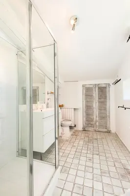 a bathroom with a glass shower and a toilet at Beautiful Provencal Mas with swimming pool in Le Thor