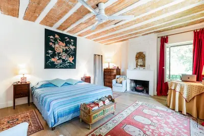 a bedroom with a bed and a ceiling fan at Beautiful Provencal Mas with swimming pool in Le Thor