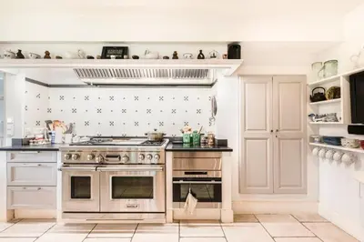 a kitchen with stainless steel appliances and white walls at Beautiful Provencal Mas with swimming pool in Le Thor