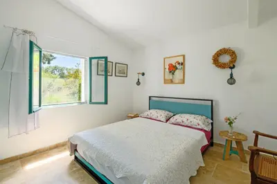 a bedroom with a bed and a window at Mas de l'Aube in Mouriès