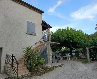 a house with a staircase on the side of it at Véritable maison de campagne nouvellement rénovée au pied du Lubéron in Cheval-Blanc