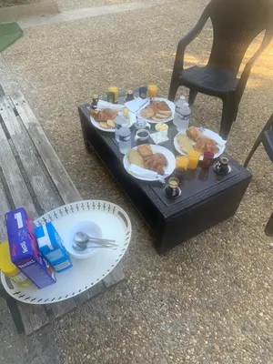 a table with breakfast food on a tray on a chair at Suite avec sauna in Pertuis