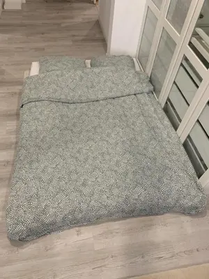 a gray blanket on the floor next to a staircase at Suite avec sauna in Pertuis