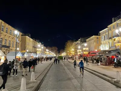 a group of people walking down a street at night at Studio Tout confort Centre historique rue calme Climatisation in Aix-en-Provence