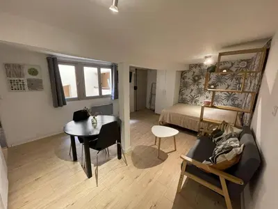 a room with a bed and a desk and a table at Studio Tout confort Centre historique rue calme Climatisation in Aix-en-Provence