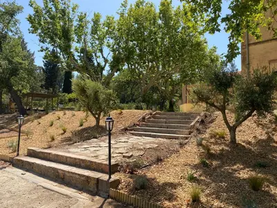a set of stairs in a park with trees at Appartement de standing dans une bastide Aixoise in Aix-en-Provence