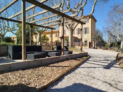 a pavilion with benches in front of a building at Appartement de standing dans une bastide Aixoise in Aix-en-Provence