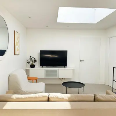 a living room with a couch and a tv at Maison moderne jardin piscine et parking prives, près d'Aix Centre in Venelles