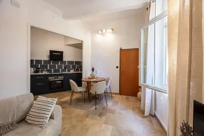 a living room with a couch and a table at La Suite Provençale in Aix-en-Provence