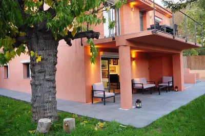 a house with a porch with chairs and a tree at Madehouse - T3 indépendant-Piscine-Centre ville Aix à pied-Stationnement gratuit dans la rue in Aix-en-Provence