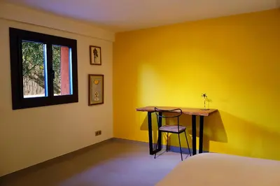 a yellow room with a table and a window at Madehouse - T3 indépendant-Piscine-Centre ville Aix à pied-Stationnement gratuit dans la rue in Aix-en-Provence