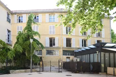 a building with a fence in front of it at La Rotonde - Magnifique Appartement climatisé avec parking in Aix-en-Provence