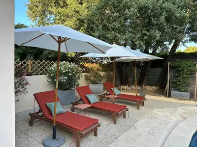 a group of chairs and an umbrella on a patio at La Provence in Maubec