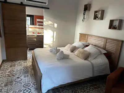 a bedroom with a large bed with towels on it at La Provence in Maubec