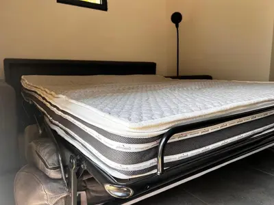a stack of mattresses sitting on top of a bed at L'Escale in Meyreuil
